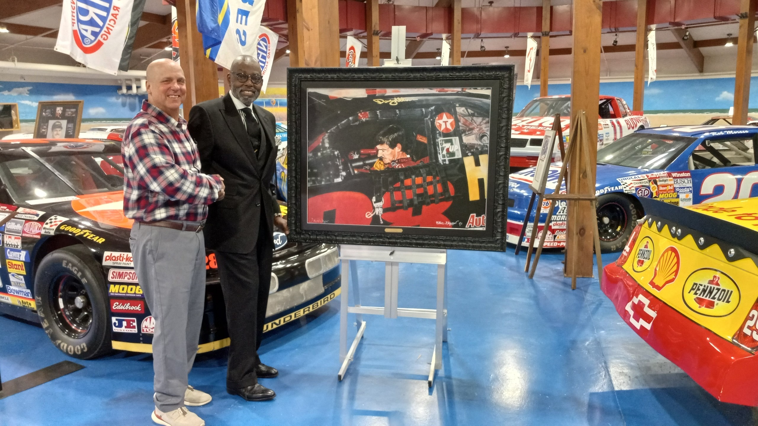 Steve Skipper donates portrait of Davey Allison Steve Skipper and Mike Raita of the IMHOF shake hands
