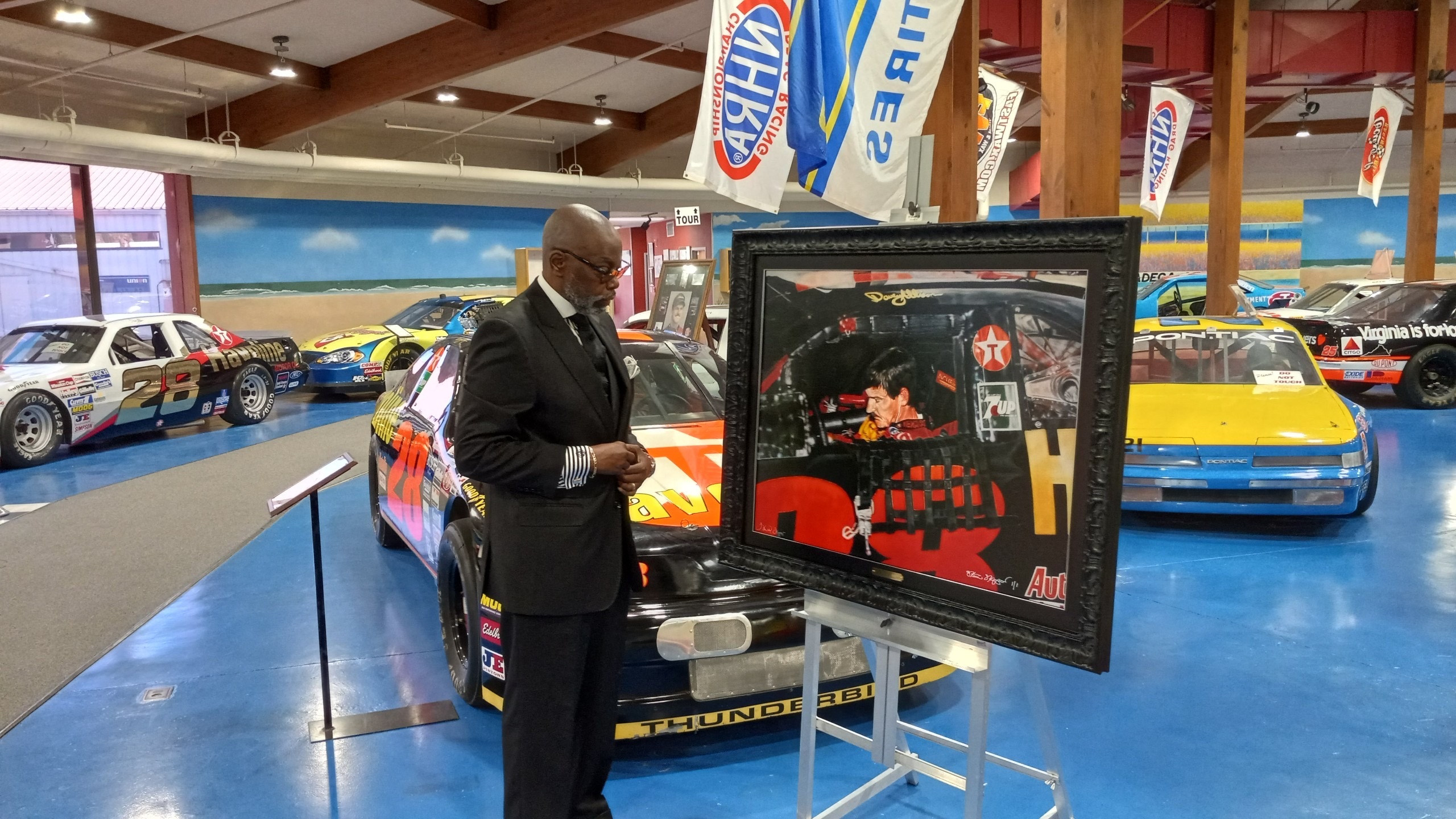 Steve Skipper donates portrait of Davey Allison Steve Skipper Standing Next To His Portrait Of Davey Allison